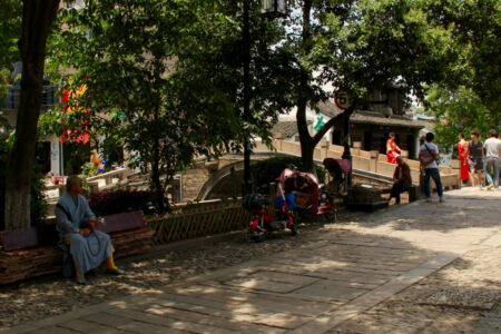Relax in the shade along Pingjiang Road People relaxing along Pingjiang path