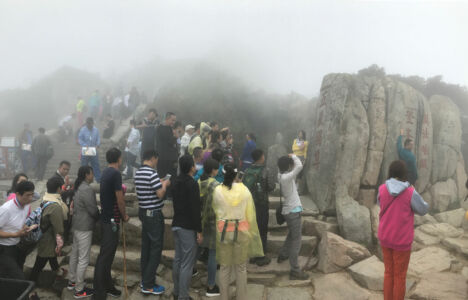 Crowds gather around the most famous rock on the mountain Crowds gather around the most famous rock on the mountain