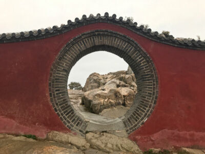 Where does it lead to? Round gate in red wall