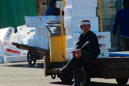 A well deserved smoke break after a long morning's work. Worker at Tsukiji market