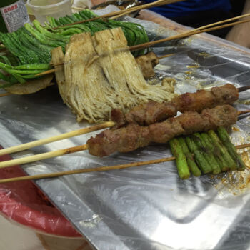 Grilled garlic shoots, mushrooms, kebab, and asparagus grilled vegitables