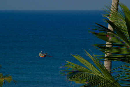 Here is a zoom view to see the fishermen out in the water Zoom in view of fising boat