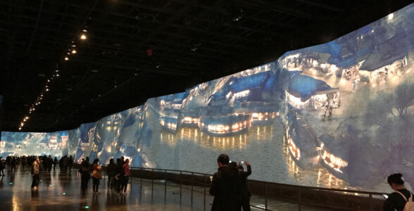 The undulating wall is covered with video displays that show animated scene from famous painting called "Riverside Scene at Qingming Festival" Electric river scene wall