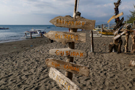 Directional sign on a beach