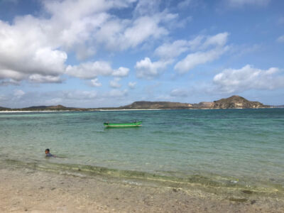 Kid swimming near a boat