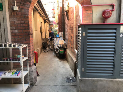 Man in ally with bicycle