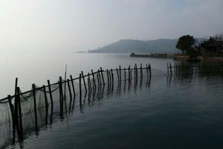 I think this fence is for keeping fish inside their pen. Fish pen
