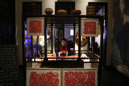 This man is making paper cuttings and they are way cool man making paper cuttings