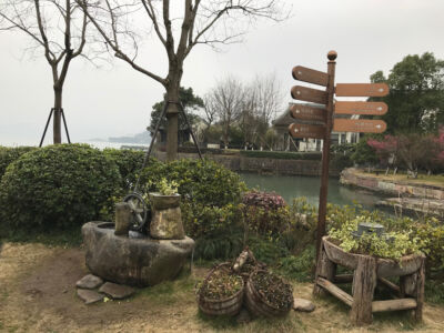 This spot just outside the tea house was much photographed. water mill and direction sign