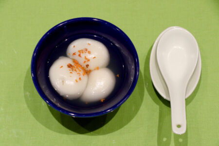 Tang yuan is a traditional treat served around Chinese New Year. It is rice gluten filled with sweet sesame paste. Tang yuan