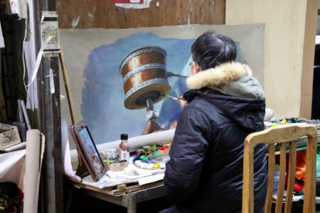 Copying from a photo on his iPad. Artist making a copy from a photo