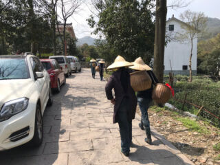 Ladies walking with tea baskets