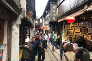Most of the streets are quiet narrow and packed with shops narrow street at Zhouzhuang Water Town