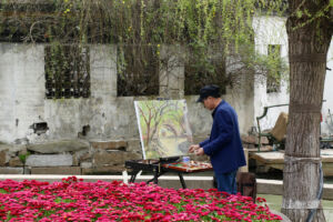 Painter alongside canal