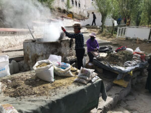 Burning incense outside of the monastery. Burning incense